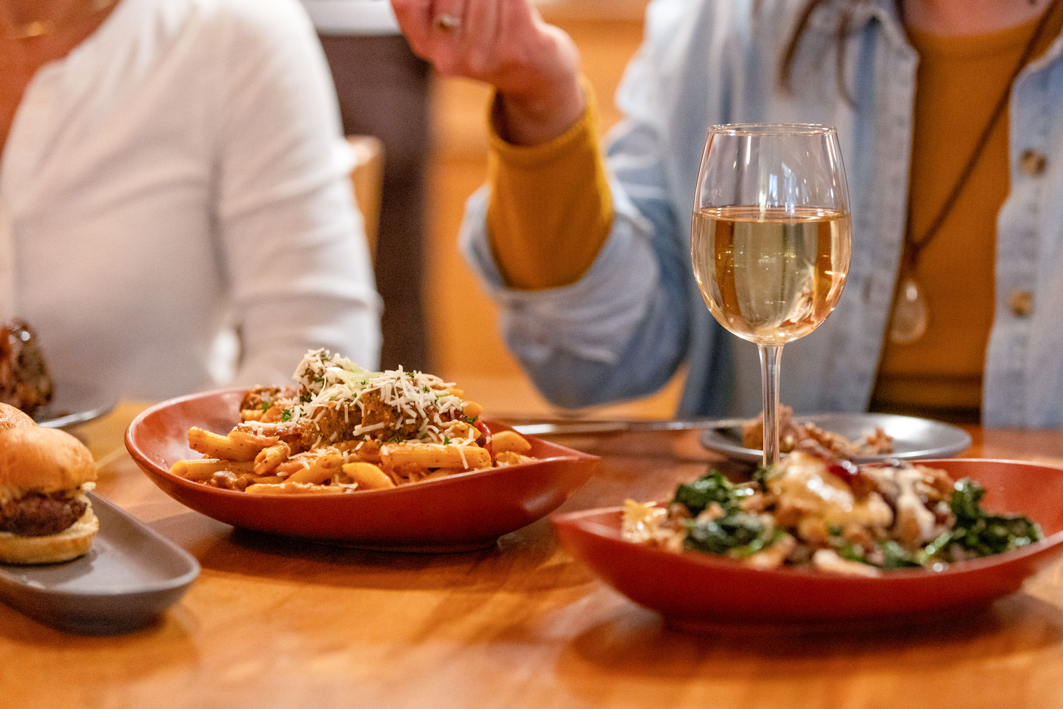 group enjoying pasta and wine at the meatball restaurant